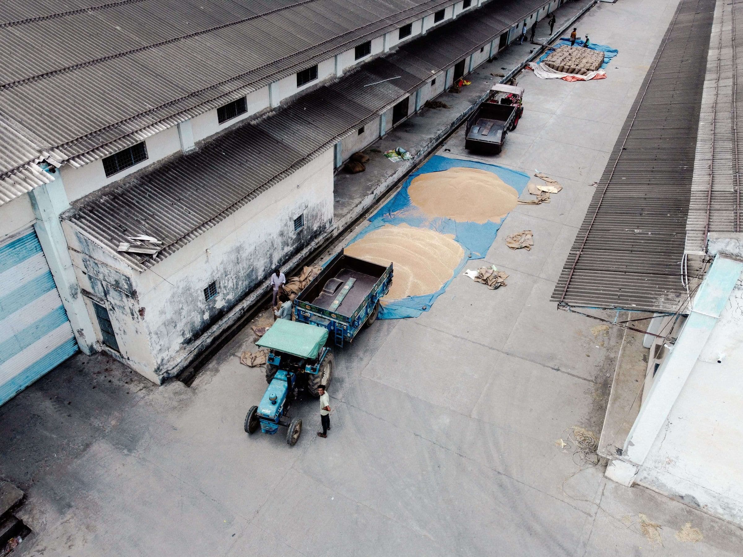 Grain being handled outside a warehouse unit